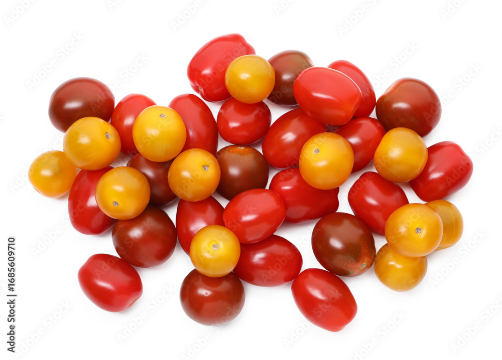 Obraz premium Heap of different ripe juicy tomatoes isolated on white, top view