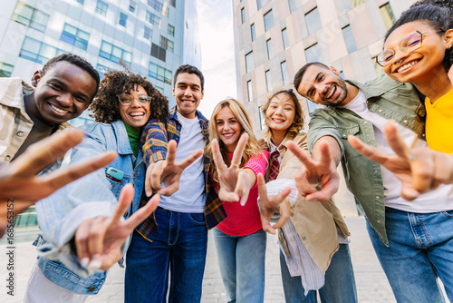 Wallpaper Mural Group of cheerful multi-ethnic students gesturing peace sign with fingers while standing together in the city Torontodigital.ca