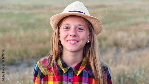 A Happy 10-Year-Old Girl. Portrait of a Kid with a Hat in Summer. Summer Style. A 10-Year-Old Kid with a Hat and a Checkered Shirt