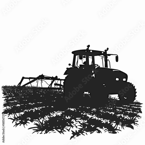 Silhouette of tractor working in field with equipment during daytime  
