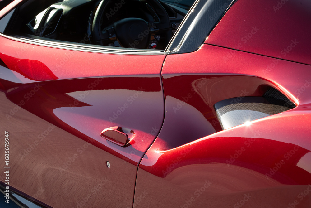 Fototapeta premium Partial side view of air intake in red sports car
