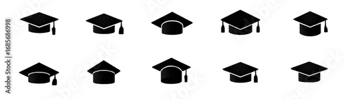 Multiple black graduation caps in various orientations on a dark background