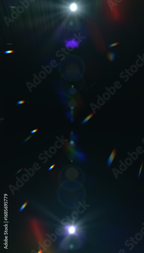 Dark abstract background with colorful light streaks, lens flares and bokeh effects. Mysterious atmosphere with blue, purple and rainbow light elements.