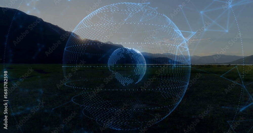 Obraz premium Floating digital holographic globe glowing above grassy plain at sunset, with network grid overlay