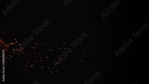 Wallpaper Mural Slow motion vertical shot of fire and sparks and embers from campfire flying over black background Torontodigital.ca