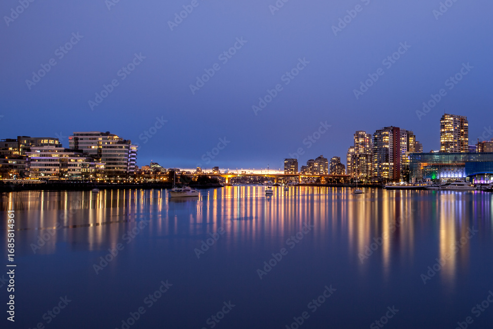 Fototapeta premium Vancouver, Canada - April 09, 2017: The city of Vancouver illuminated at night with the famous BC stadium.