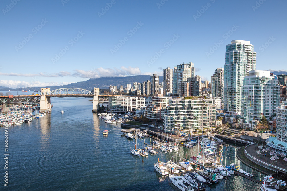 Naklejka premium Vancouver, Canada - April 11, 2017: Burrard Street Bridge, art Deco-style steel bridge from the 1930s on four tall pillars overlooking the docks and Granville Island.