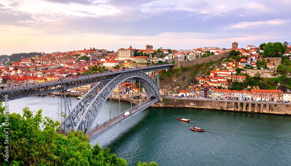 Fototapeta premium Panoramic view of a city on a river with a bridge