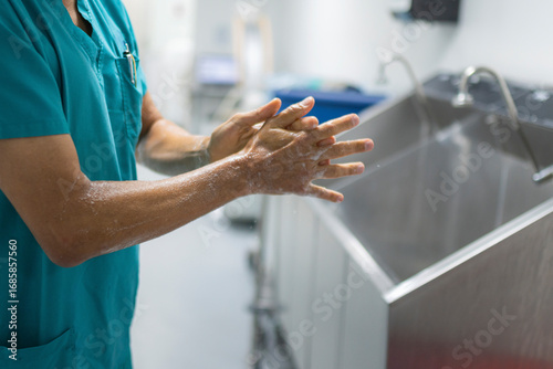 Close up of surgeon washing hands before surgery in hospital