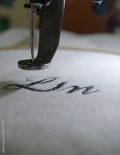 Wallpaper Mural Close-up of a sewing machine embroidering the word "Lin Torontodigital.ca