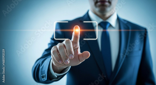 Businessman in a suit pressing a glowing virtual button on a futuristic touchscreen. Mockup with copy space.