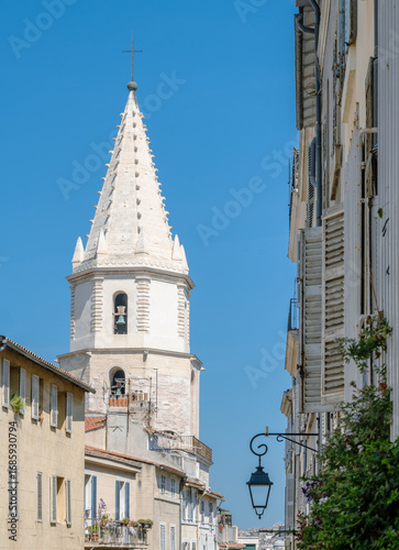 Close-up view of the bell tower of Notre-Dame-des-Accoules in the historic Panier district of Marseille, Provence-Alpes-Côte d'Azur, France. A bright Mediterranean summer scene