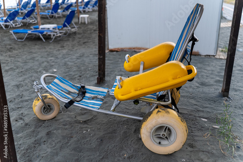 Beach wheelchair for people with disabilities on the sandy beach of Limassol, Cyprus. Equipment designed for comfortable seaside access and relaxation.
