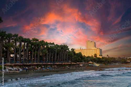 Limassol promenade in Cyprus, beach in the evening sun with a beautiful sunset over the city of Limassol.
