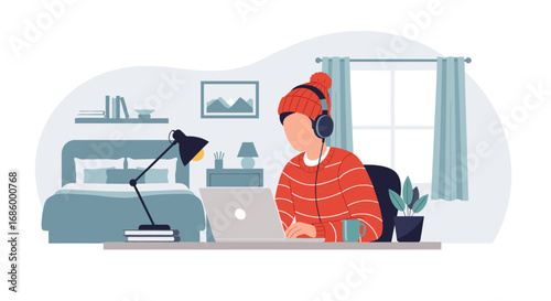 Person in a cozy home environment, wearing headphones and a beanie, focused on remote work or study using a laptop. Ideal for lifestyle and business concepts.