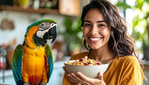 A beautiful person with long hair smiles while holding a bowl of granola with a colorful parrot