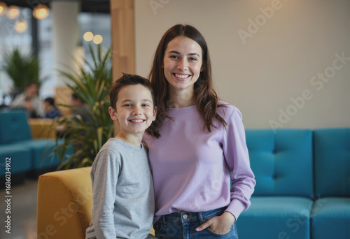 Parent and child smiling together at the entrance of an entertainment center