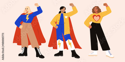 Three diverse women in superhero capes and bold outfits striking powerful poses celebrating strength and unity