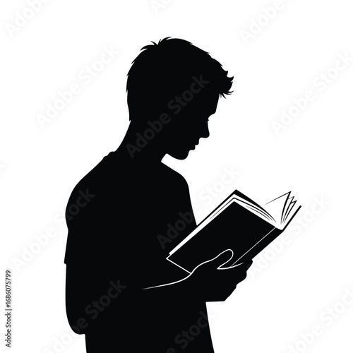 Silhouette of a young man engrossed in reading a book.