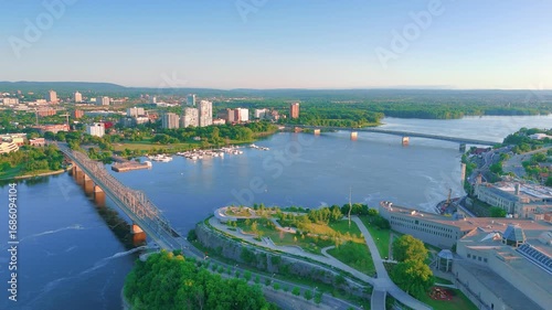 Wallpaper Mural Aerial view of Ottawa's Alexandra and Macdonald-Cartier Bridges over the Ottawa River, uniting urban landscapes with lush parkland under a clear sky. Torontodigital.ca