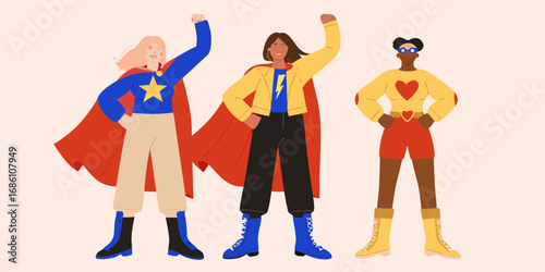 Three diverse women in superhero costumes with capes and boots striking a confident pose