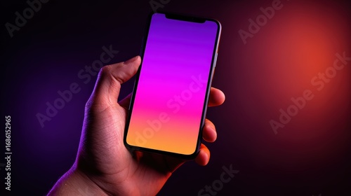 Close-up of a hand holding a modern smartphone with a colorful gradient screen, illuminated against a dark and vibrant background