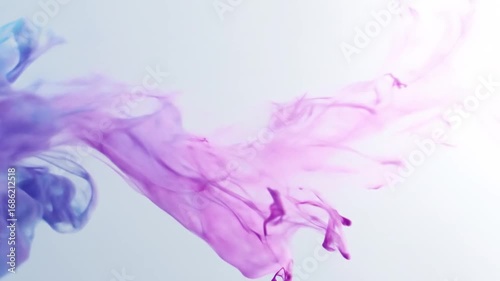 Vibrant swirls of blue and purple ink create a mesmerizing visual display against a light background.