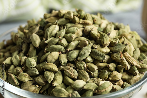 Fotografía Glass bowl with cardamom spice on grey background, closeup