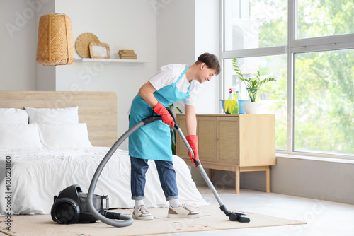 Young male janitor with mod...