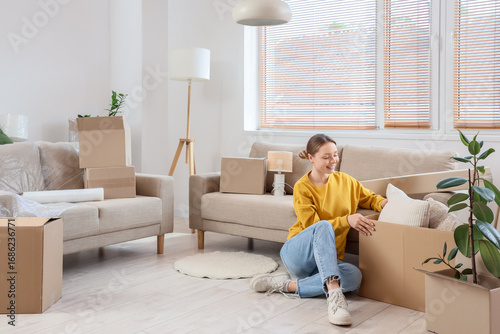 Young woman with box sittin...
