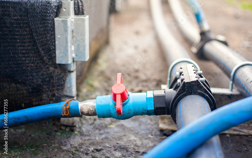 Close-up of a water pump. Agricultural water piping system. PVC pipe connectors.
