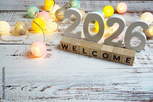 Welcome 2026 word alphabet letters on wooden background