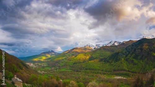 Time lapse: Rustic village Varaita Valley Piedmont Italy with snow capped Alps in background under pastel sunset sky blending nature architecture serenity