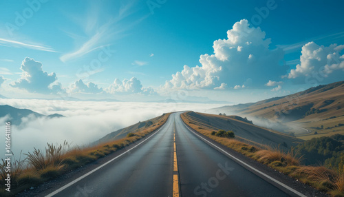 A scenic road leads into a dreamy landscape of clouds and mountains under a bright sky.