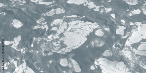 Aerial view of melting ice on ocean surface showing textured abstract patterns with swirling water movements