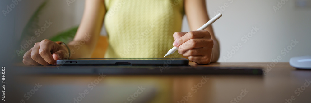 Fototapeta premium Graphic designer working on digital tablet. artist drawing on graphic tablet and Color swatch samples. Artist Creative Designer sketch graphic drawing creative creativity draw studying work on tablet