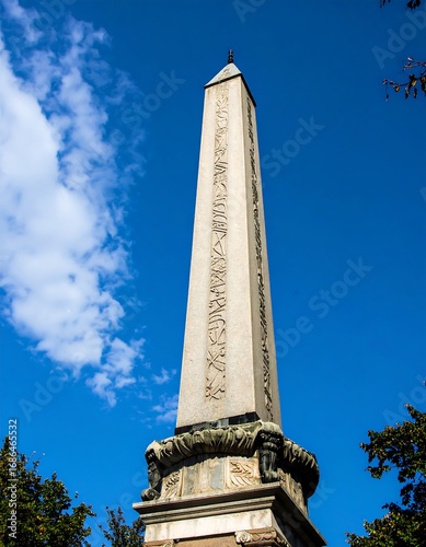 Ancient obelisk against blue sky