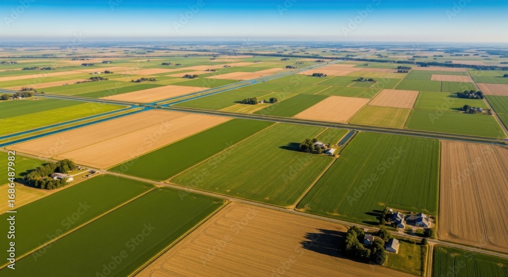 Obraz premium Aerial View of Green and Brown Agricultural Fields Under Clear Blue Sky