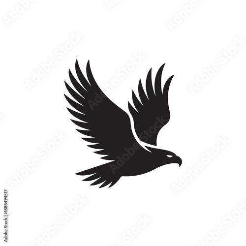 Silhouette of a black eagle in flight against a white background