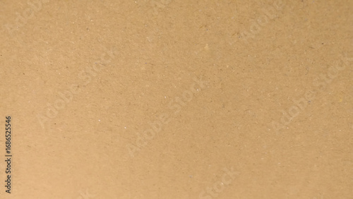 Background of brown kraft paper or cardboard texture. Abstract pattern of beige rough carton, old paper sheet, parchment or papyrus surface.