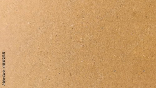 Background of brown kraft paper or cardboard texture. Abstract pattern of beige rough carton, old paper sheet, parchment or papyrus surface.