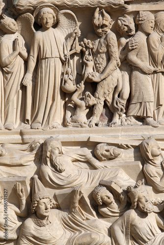 Notre Dame de Paris cathedral.  Western facade. Portal of the Last judgement. St Michael weighing the souls. Resurrection of the deads..   Paris. France.