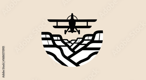Vintage biplane flying over a stylized canyon logo design.