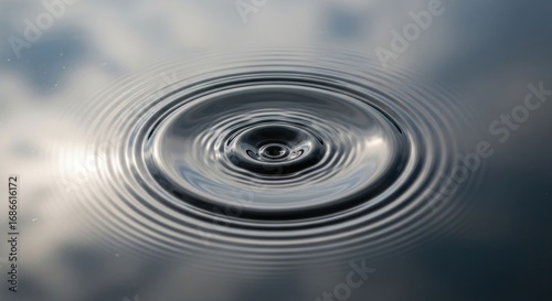 Water ripples emanate from center point, reflecting sky