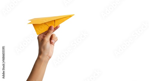 A hand holds a bright yellow paper airplane against a plain white backdrop