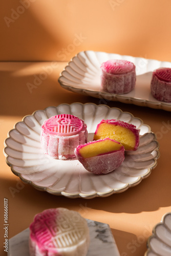 Homemade Chinese snow skin mooncakes. Snowy Moon cakes on a White Background. traditional Asian desserts for Mid-Autumn Festival and seasonal celebrations 