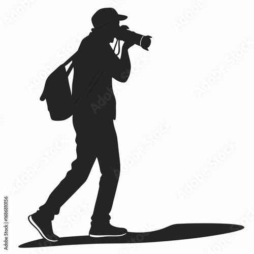 Black silhouette of a person wearing a cap and carrying a bag while taking a picture with a camera photographer