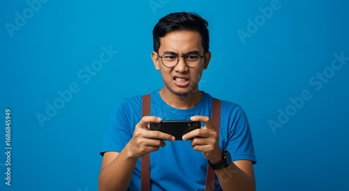 Young Man Frustrated While Playing Mobile Game on Smartphone