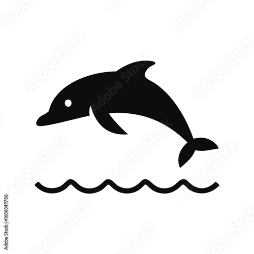 Black dolphin leaping over wavy water jumping waves