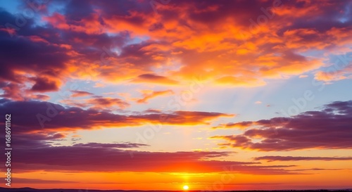 Fiery Sunset Sky with Dramatic Clouds and Golden Sunlight Glow